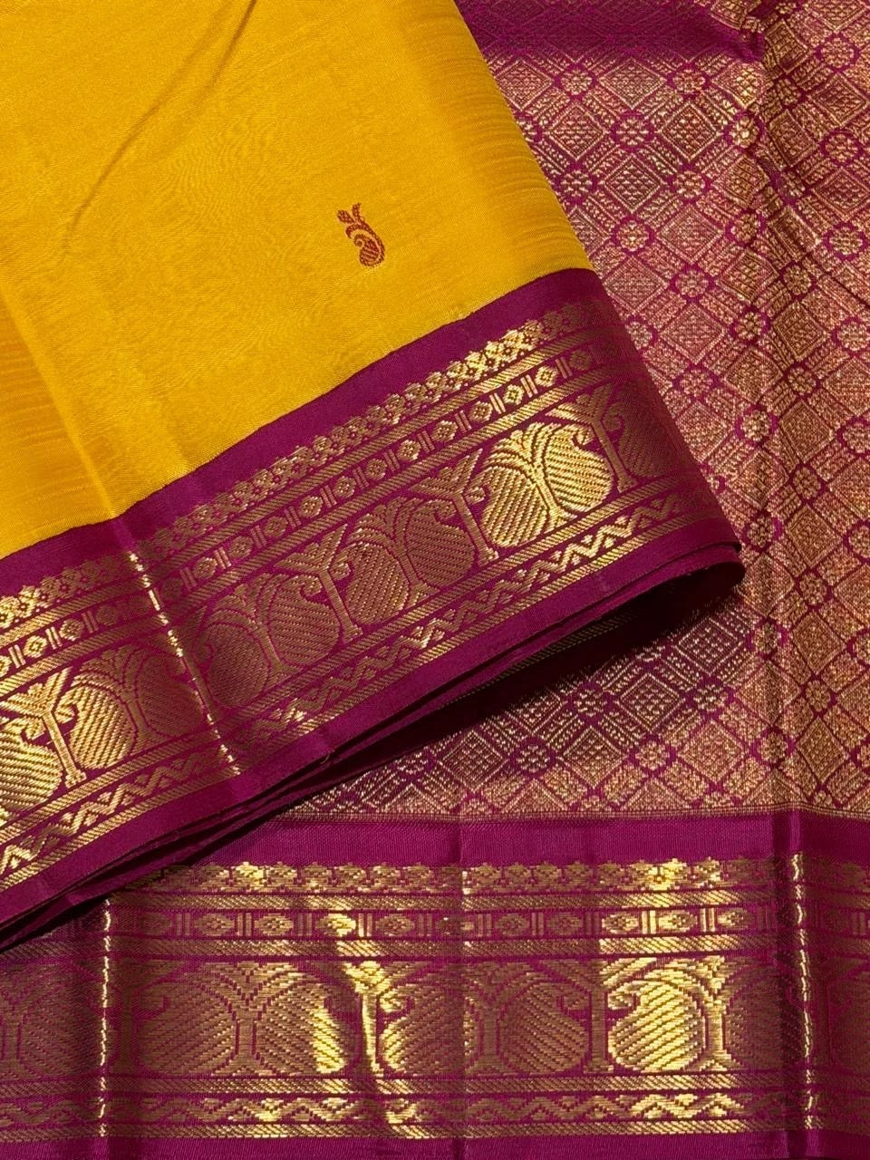 Handwoven Kanjivaram pure silk saree in mustard yellow with small green and pink silk-thread buttas and gold zari Korvai border