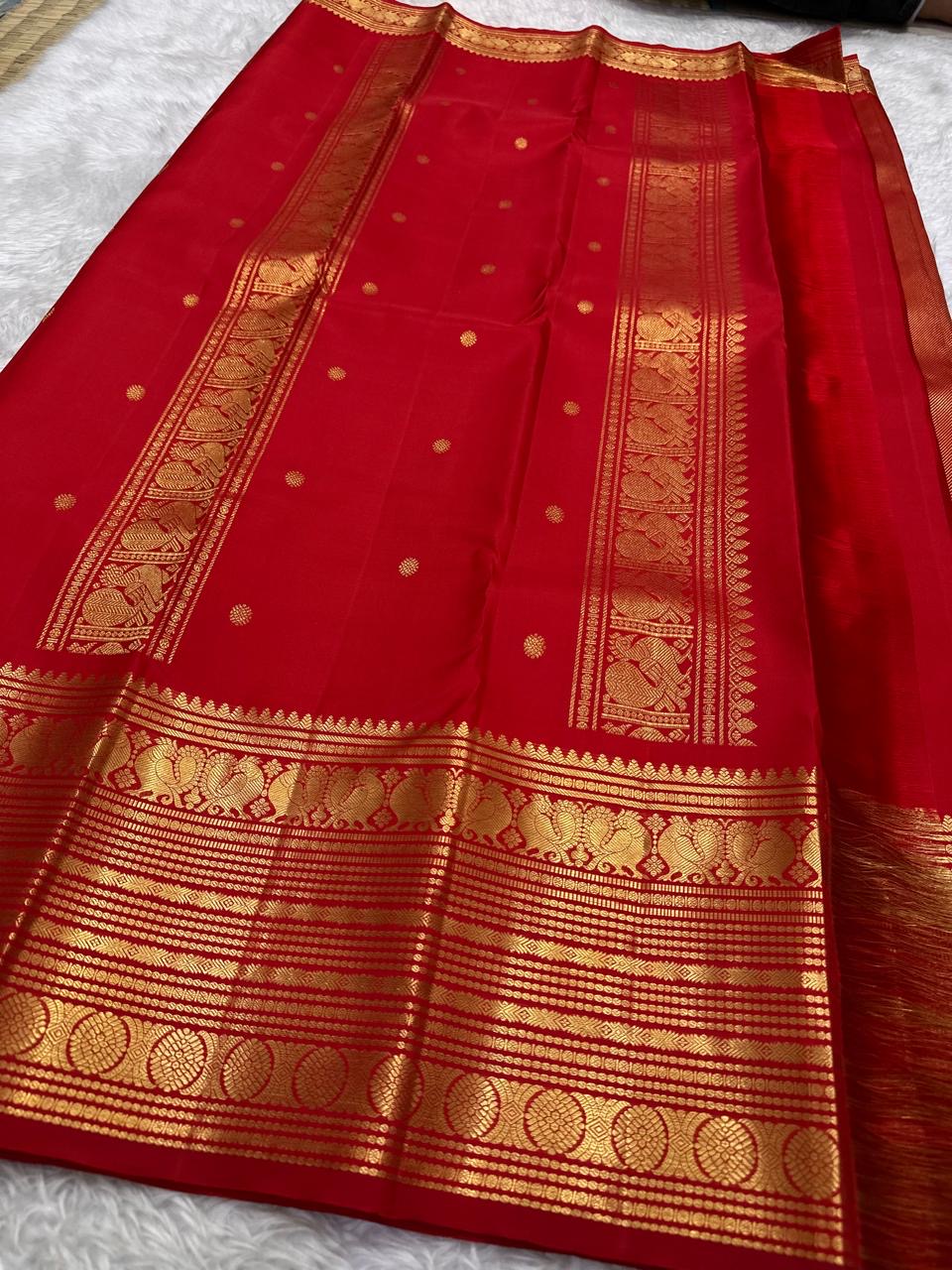 Arakku red Korvai border of rust orange Kanjipuram saree with dense Yaanai elephant and Annam swan antique gold zari array