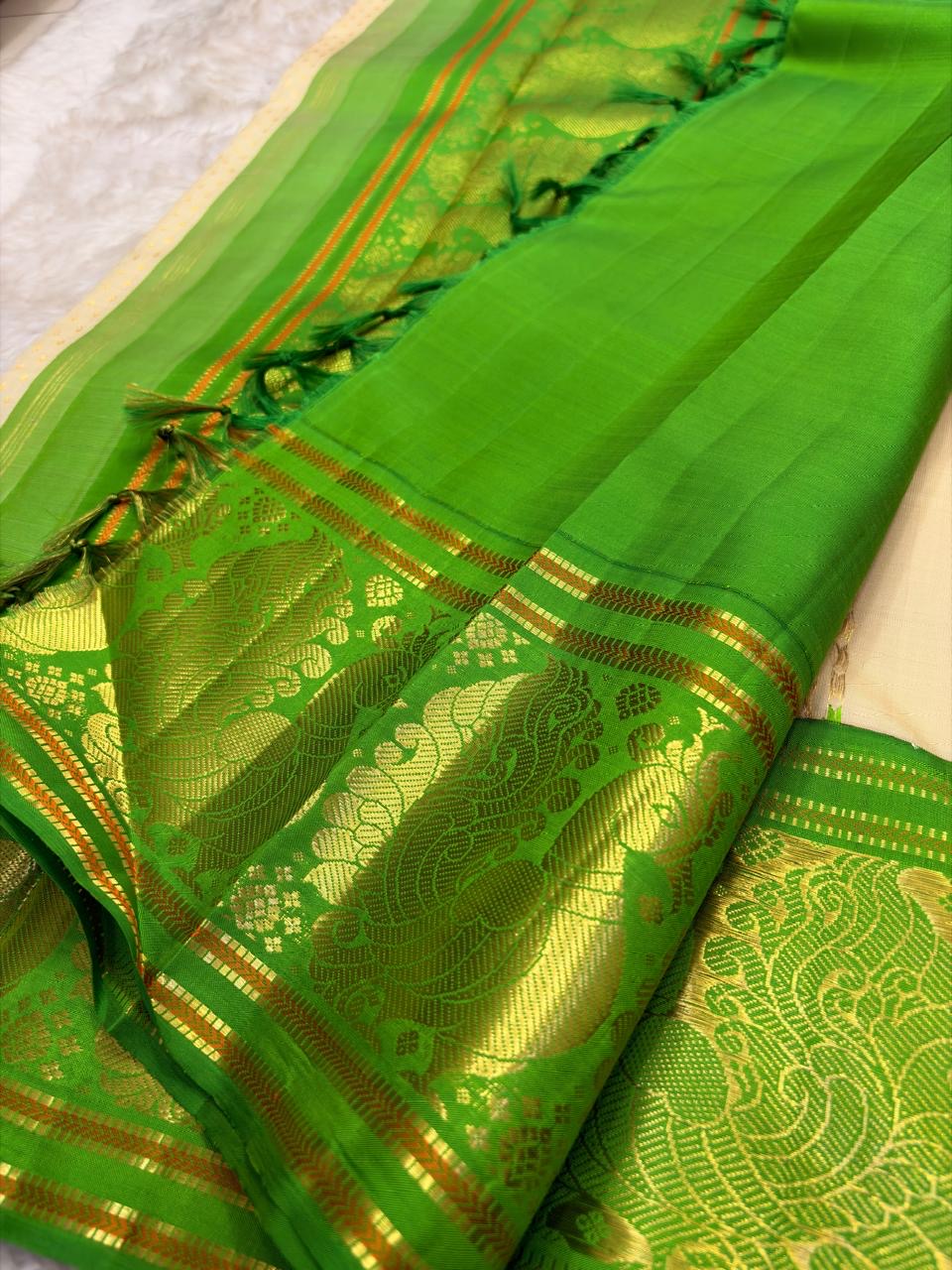 Soft ivory and emerald green Kanjipuram Korvai saree folded view