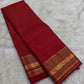 Pillar box red Kanchipuram silk saree folded on banana leaf with gold zari varisaipet border Idam Living