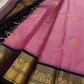 Draped pink Pure Kanchipuram Silk Saree with gold buttas and black zari border; black pallu with gold zari weave visible