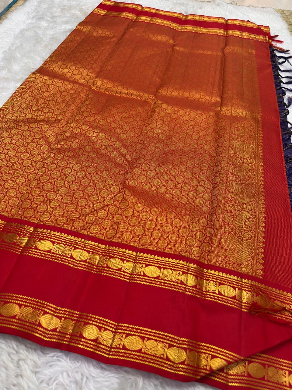 Deep navy Vairaoosi KanchiPattu pure silk saree folded, showing zari shimmer texture