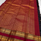 Close view of maroon pallu with gold zari woven bands, tassel edge, and deep plum purple checked Pure Kanchipuram silk saree section