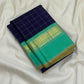 Folded navy checked Pure Kanchipuram silk saree with sea green border and gold zari woven detailing