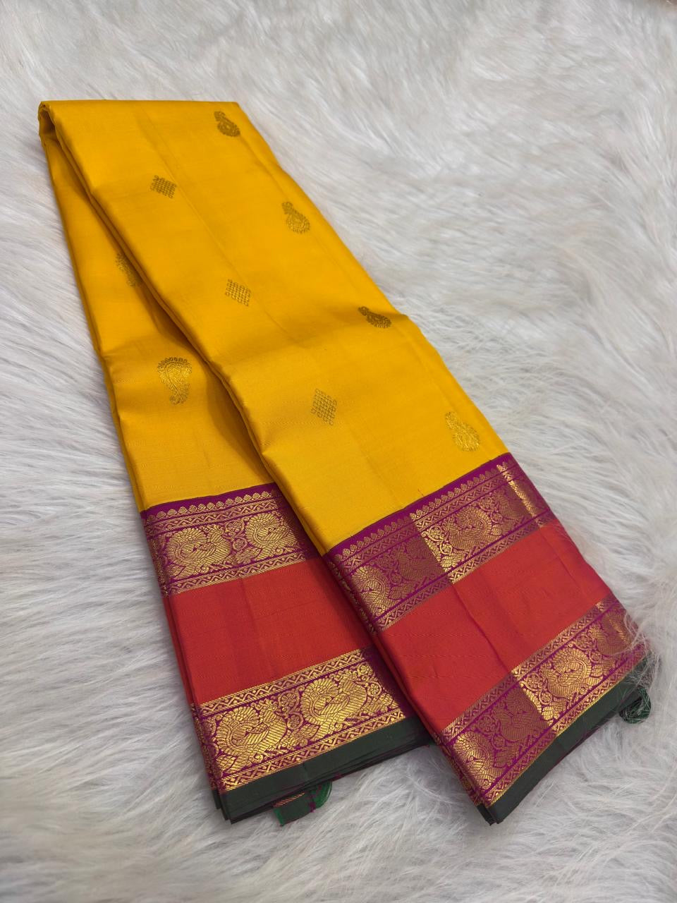 Detail of purple and coral Kanchipuram border with Mayil zari band and dark-green selvedge.