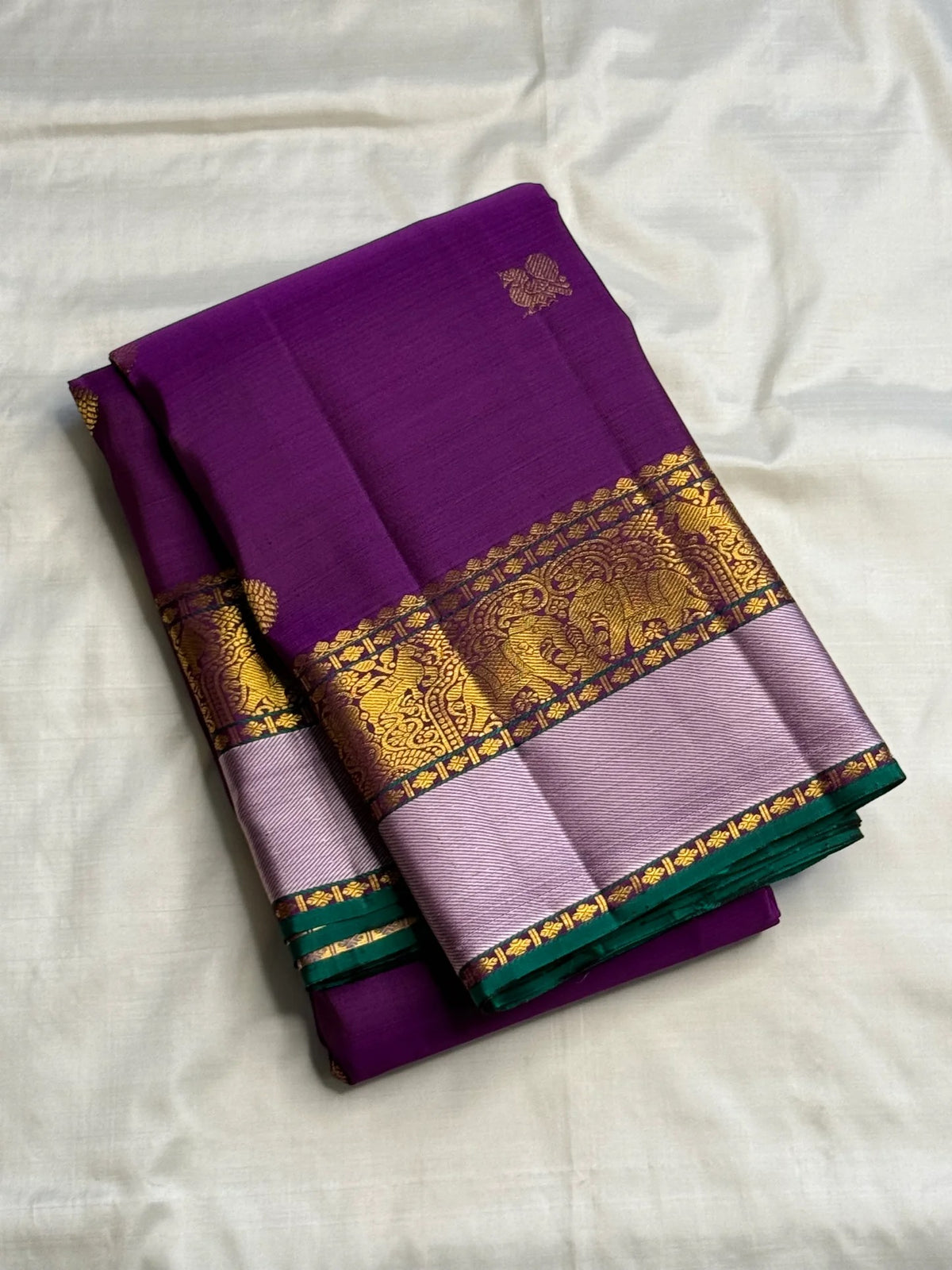 Traditional gold-zari buttas across rich Purple silk.
