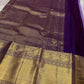 Close view of antique gold zari border and purple silk body on a Kanchipuram silk saree