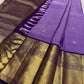 Purple Kanchipuram silk saree showing antique gold zari border detail and pallu tassels laid flat