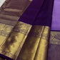 Pure Kanchipuram silk saree with purple body and wide antique gold zari pallu displayed open