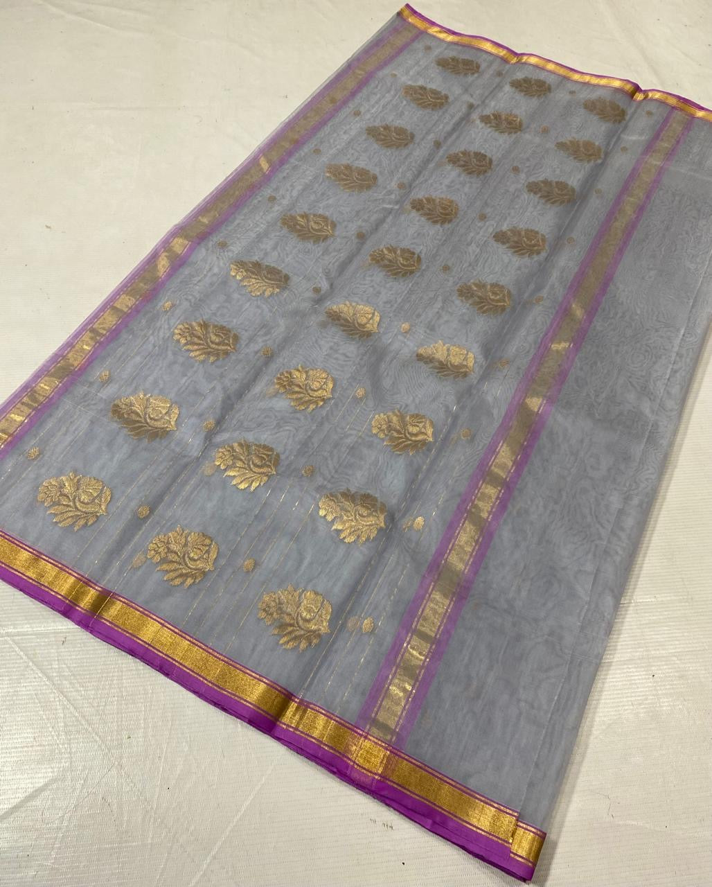 Close-up of purple and gold zari border on silver grey Chanderi silk
