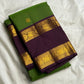 Folded green Pure Kanchipuram silk saree with small gold woven motifs and deep purple zari woven elephant border