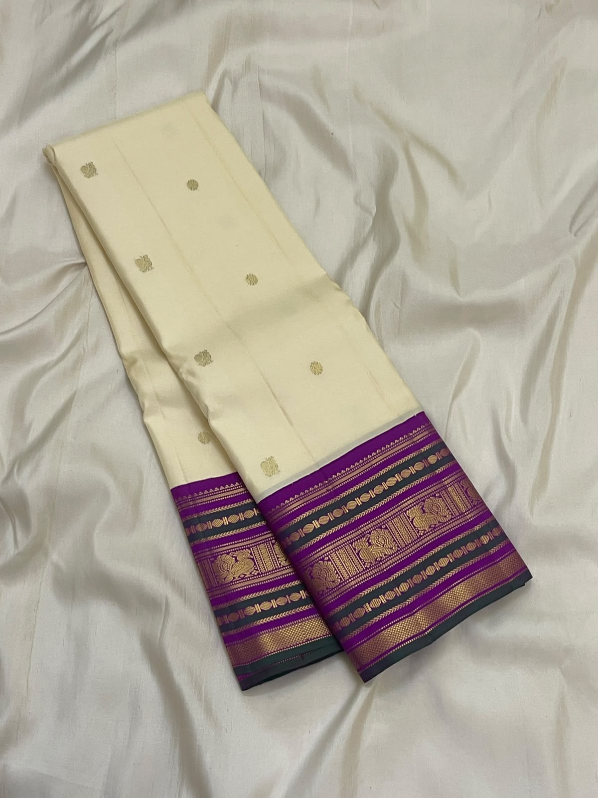 Close view of traditional gold zari border motifs on Warm Ivory Kanjivaram saree