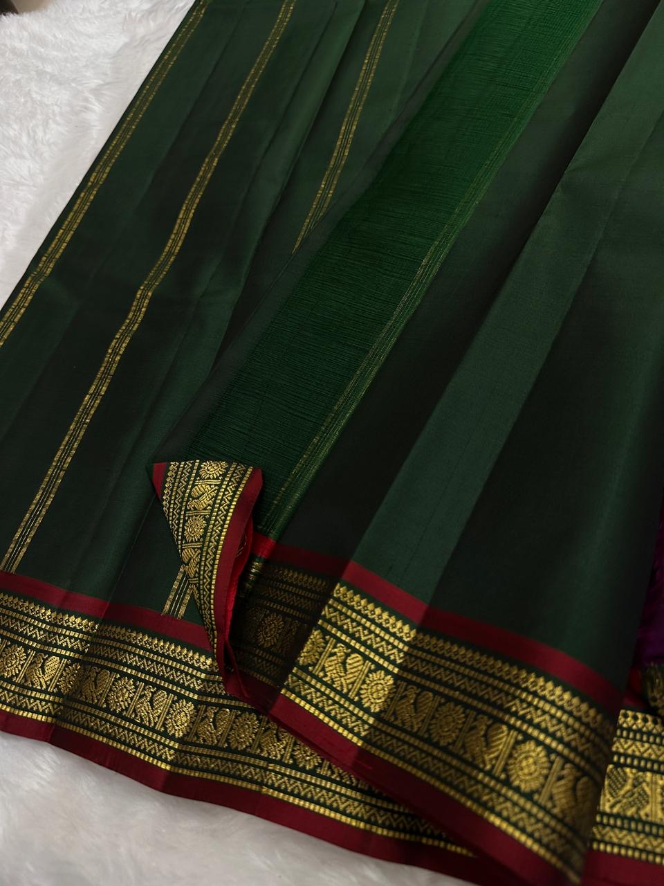 Green pure Kanchipuram silk saree body with fine vertical antique gold zari lines visible across the surface, available in the USA