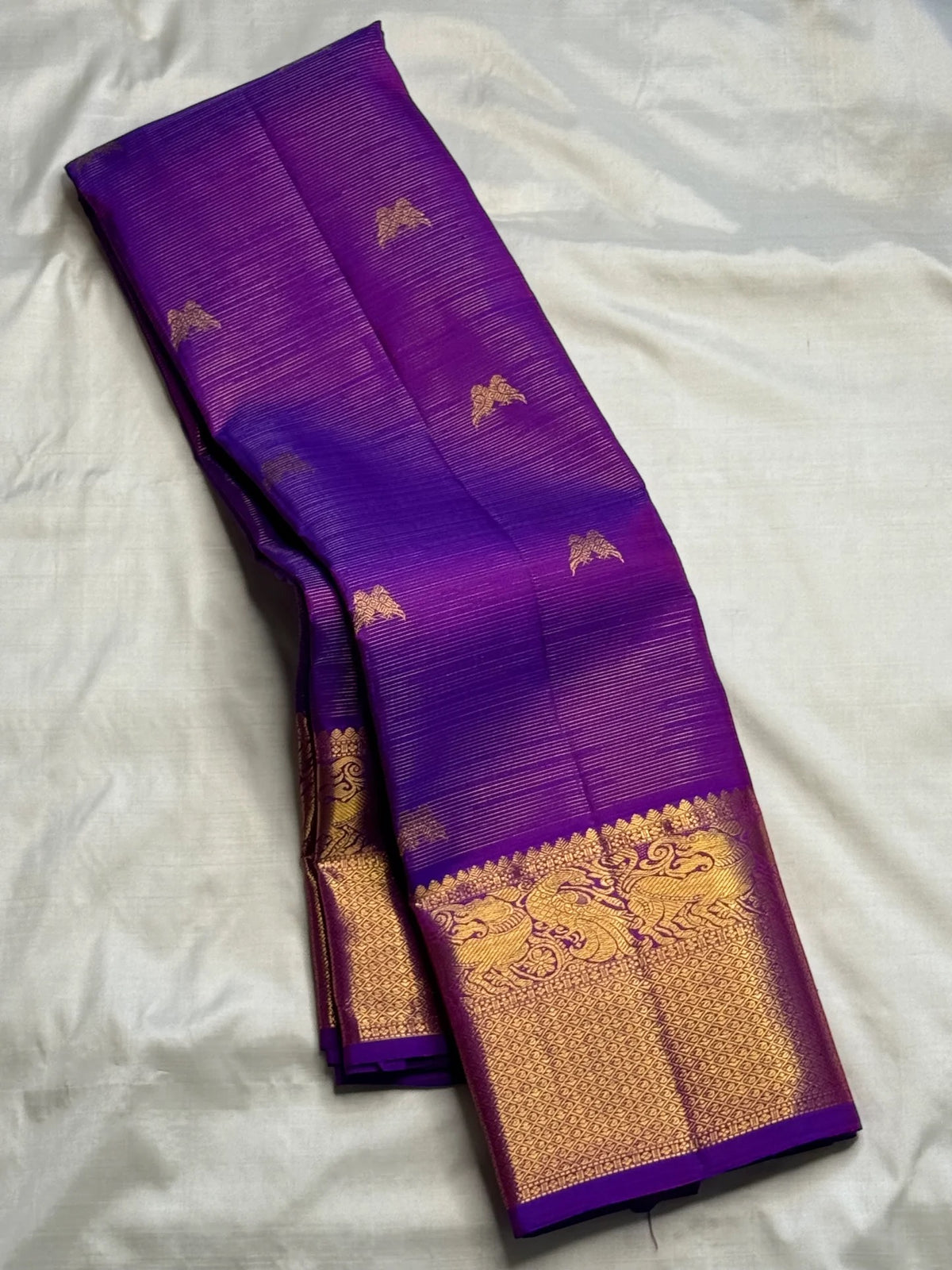 Rich Mayil gold zari border on handwoven Kathiripoo Purple Kanchipuram saree.