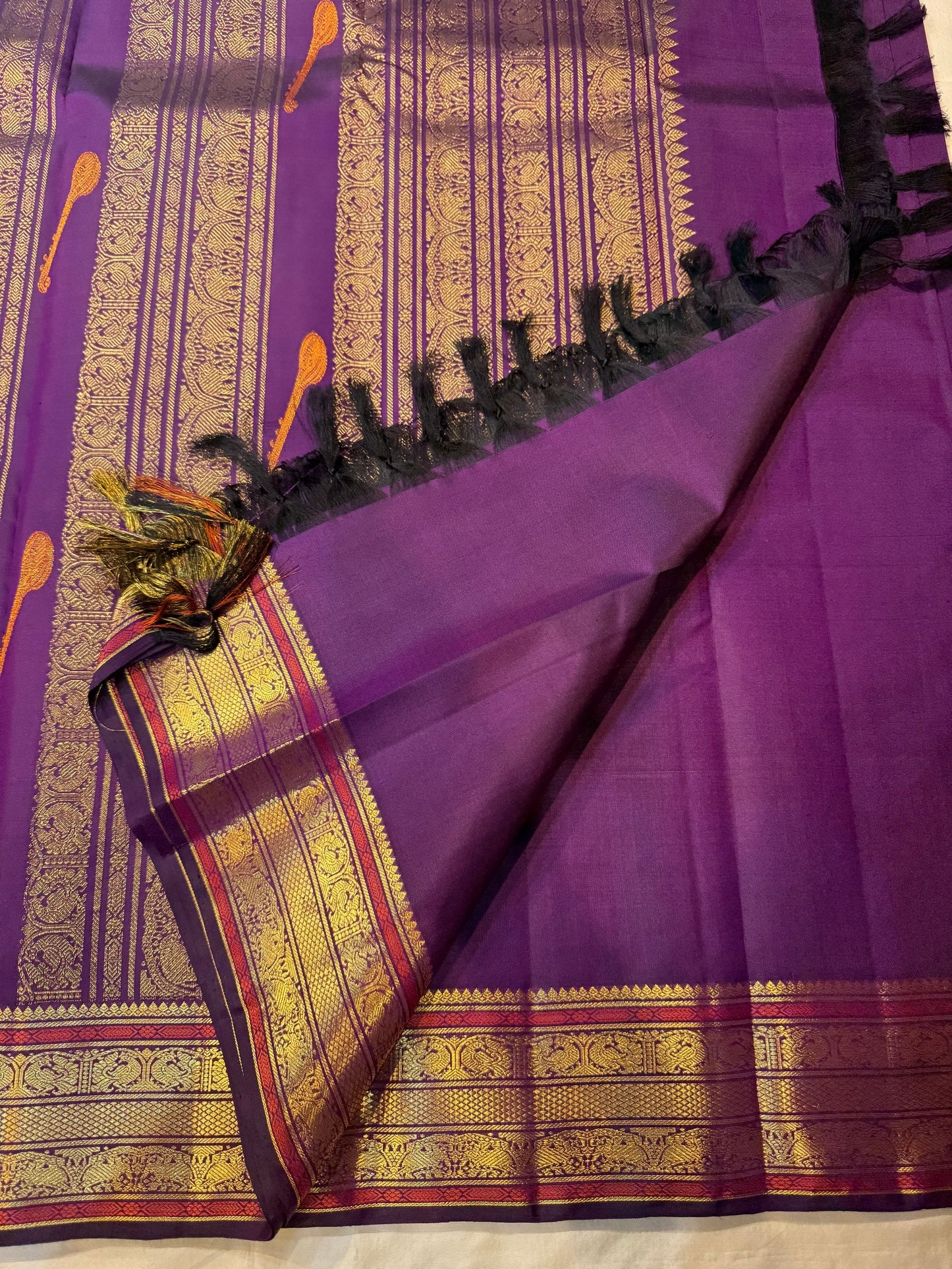 Purple Kancheepuram silk saree – meenakari butta and traditional zari detailing closeup