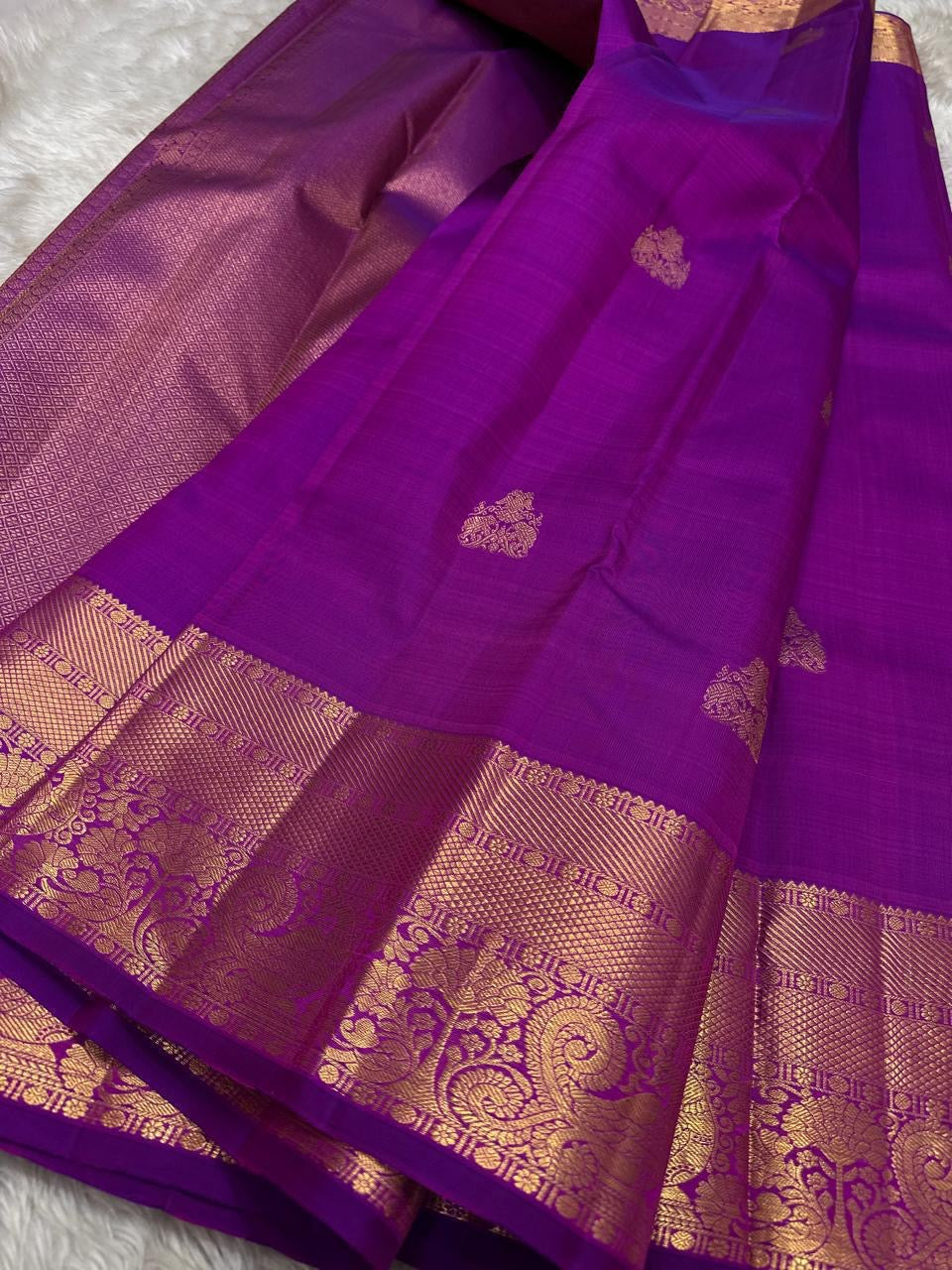 Close-up of gold zari mayil peacock butta on deep purple Kanchipuram silk saree — Idam Living