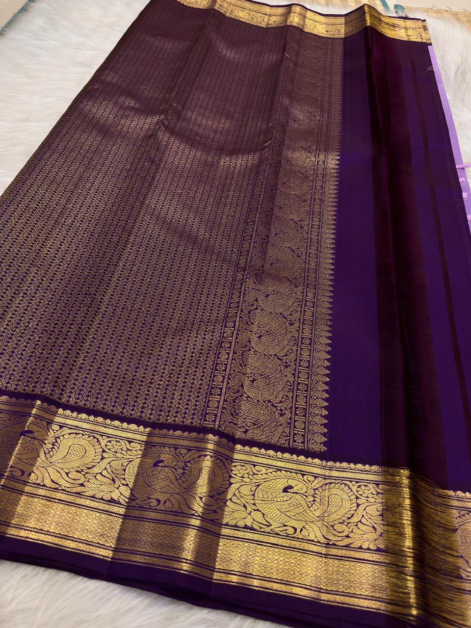 Lavender purple Kanjeevaram saree — antique-gold zari peacock border motif close-up