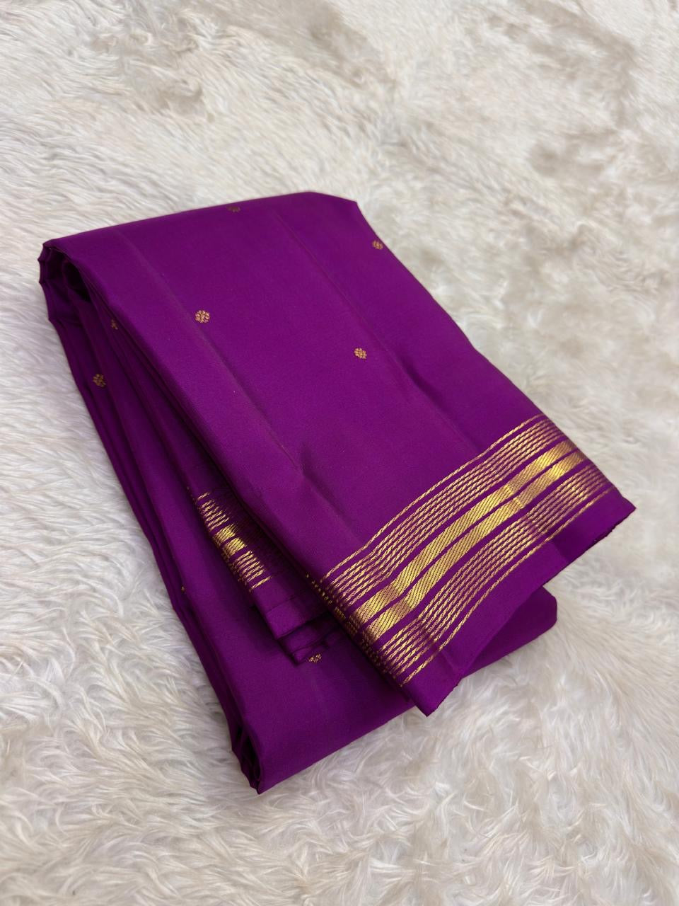 Tonal purple Kanjivaram border finished with repeated fine parallel classic-gold zari lines.
