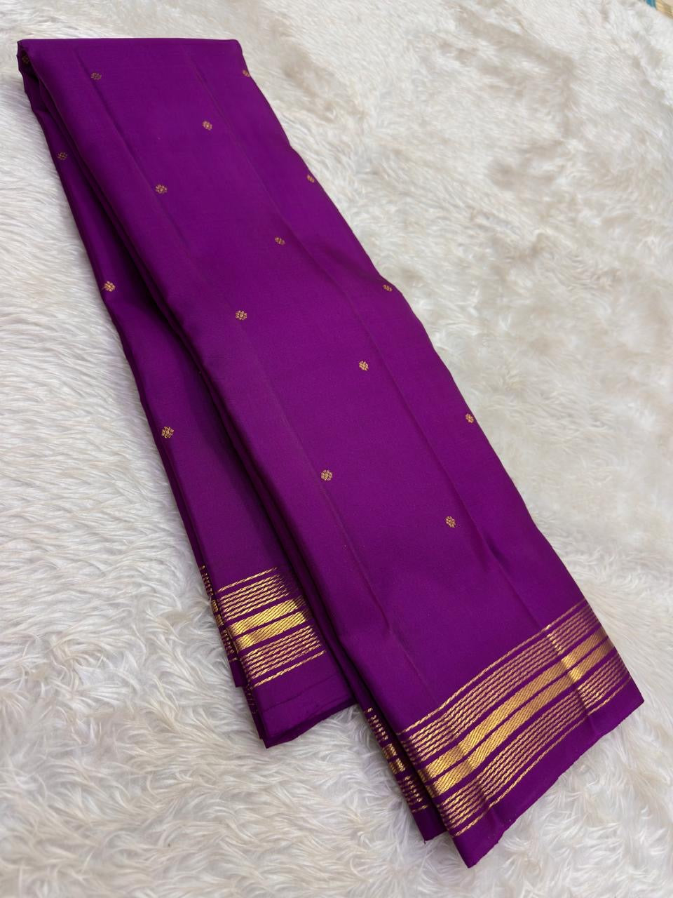 Handwoven Pure Silk Kanjivaram Butta saree with an open purple body and small gold zari clusters.