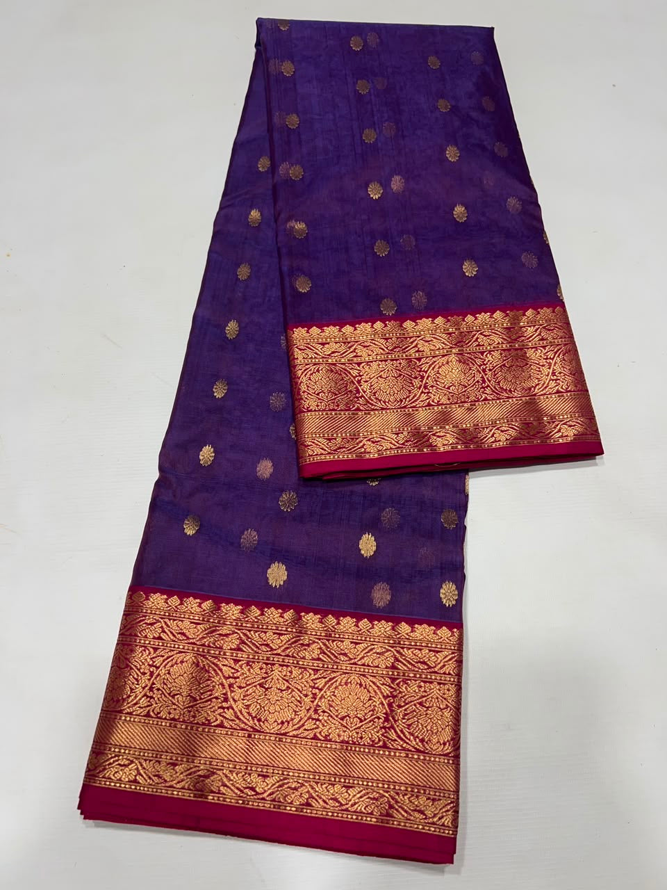 Close view of Royal Purple Katan Silk Chanderi showing small gold buttas and intricately patterned gold woven border.
