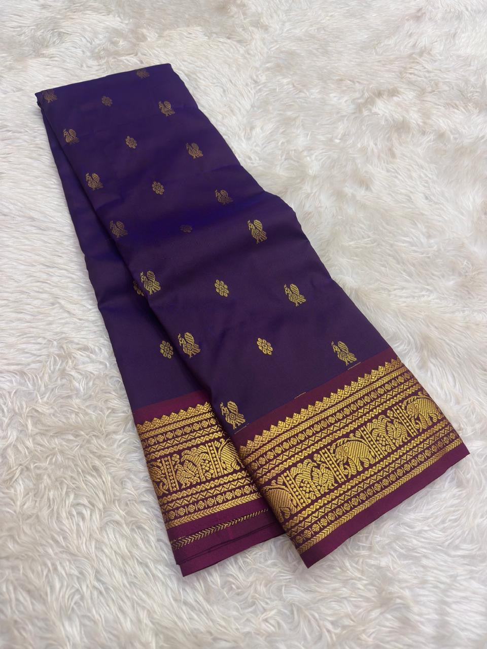 Purple lightweight Kancheepuram silk saree with intricately woven peacock border
