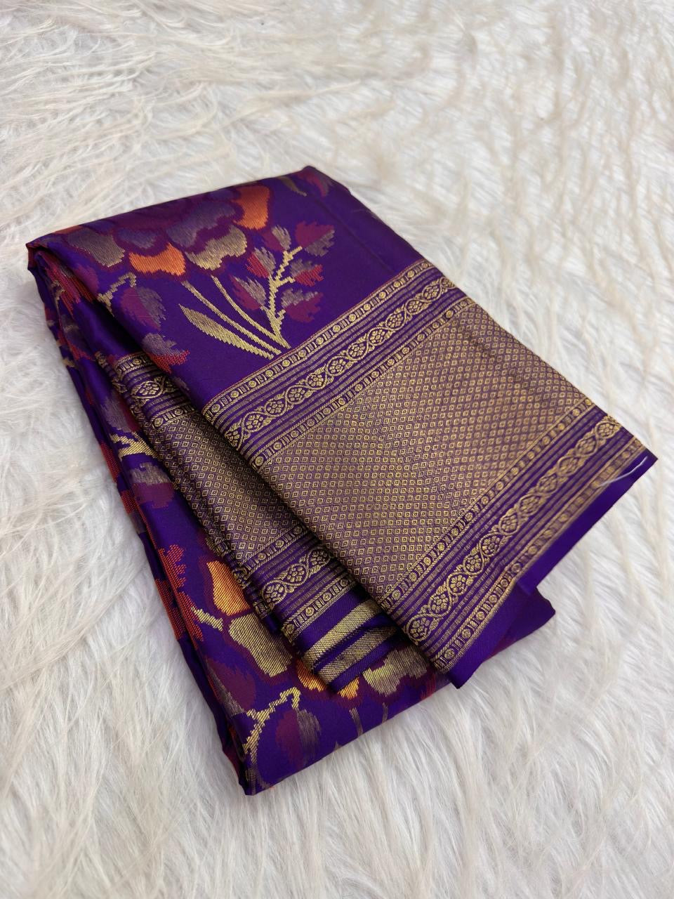 Royal Violet pure silk saree with intricate botanical zari coloration and antique-gold border.