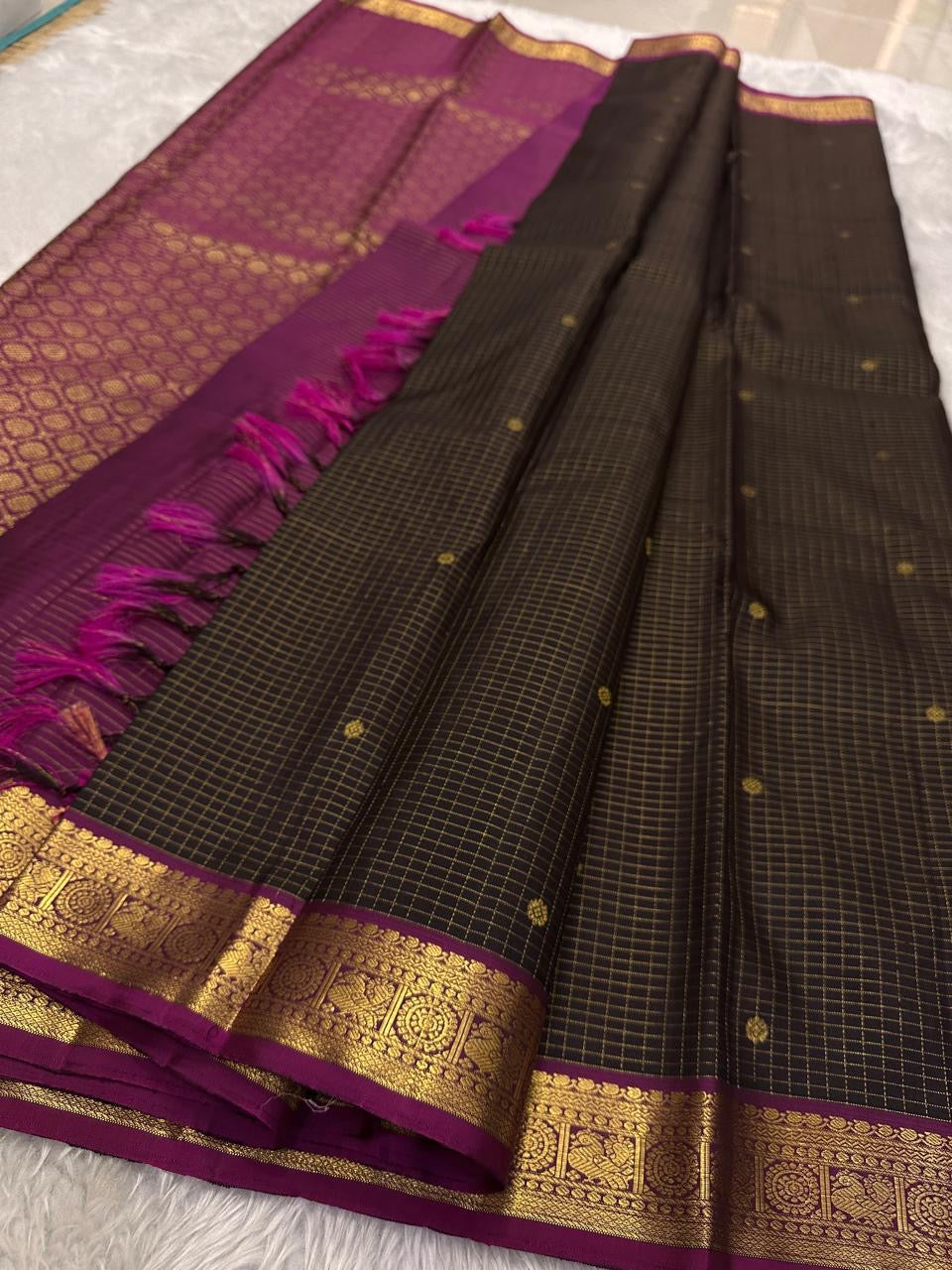 Full view of deep brown checked pure Kanchipuram silk saree with magenta zari border and tassels, available in the USA