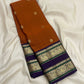 Laid-out Kanakambaram orange and purple Kanchipuram silk saree showing the contrast Rettapet and pallu.