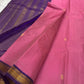 Pure Kanchipuram Silk Saree laid flat showing rose pink body with gold buttas and deep purple pallu with zari woven lines