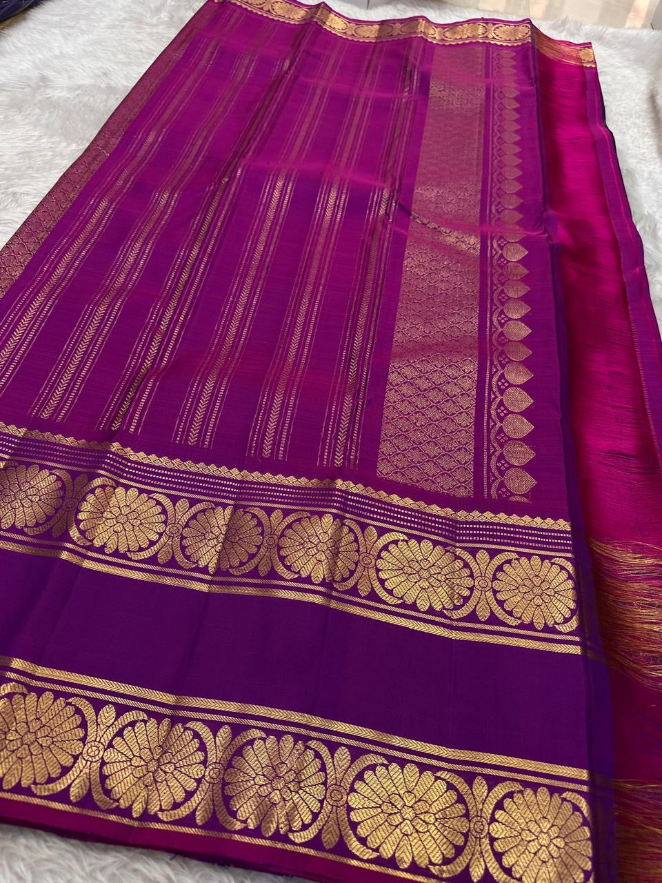 Royal purple pure silk Kanchi saree folded showing gold zari buttas