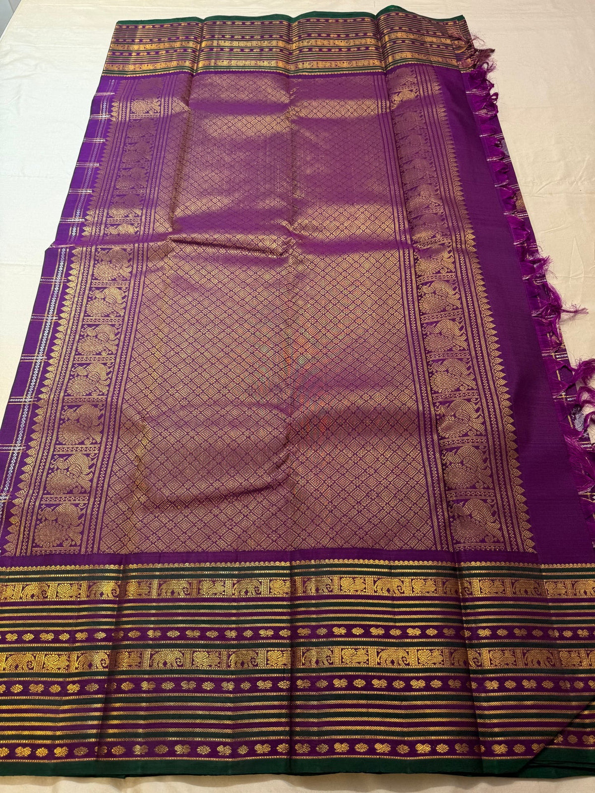 Vivid purple Pure Silk Kanjeevaram Zari Kattam saree with fine metallic lattice and alternating woven buttas.
