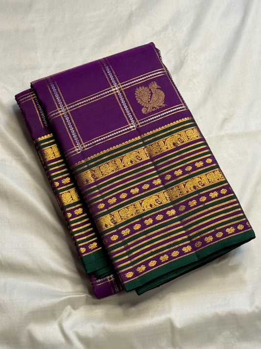 Purple Kanchipuram silk showing gold and silver-toned motifs positioned inside a precise zari grid.