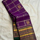 Alternating circular medallions and smaller traditional buttas across a purple zari lattice body.