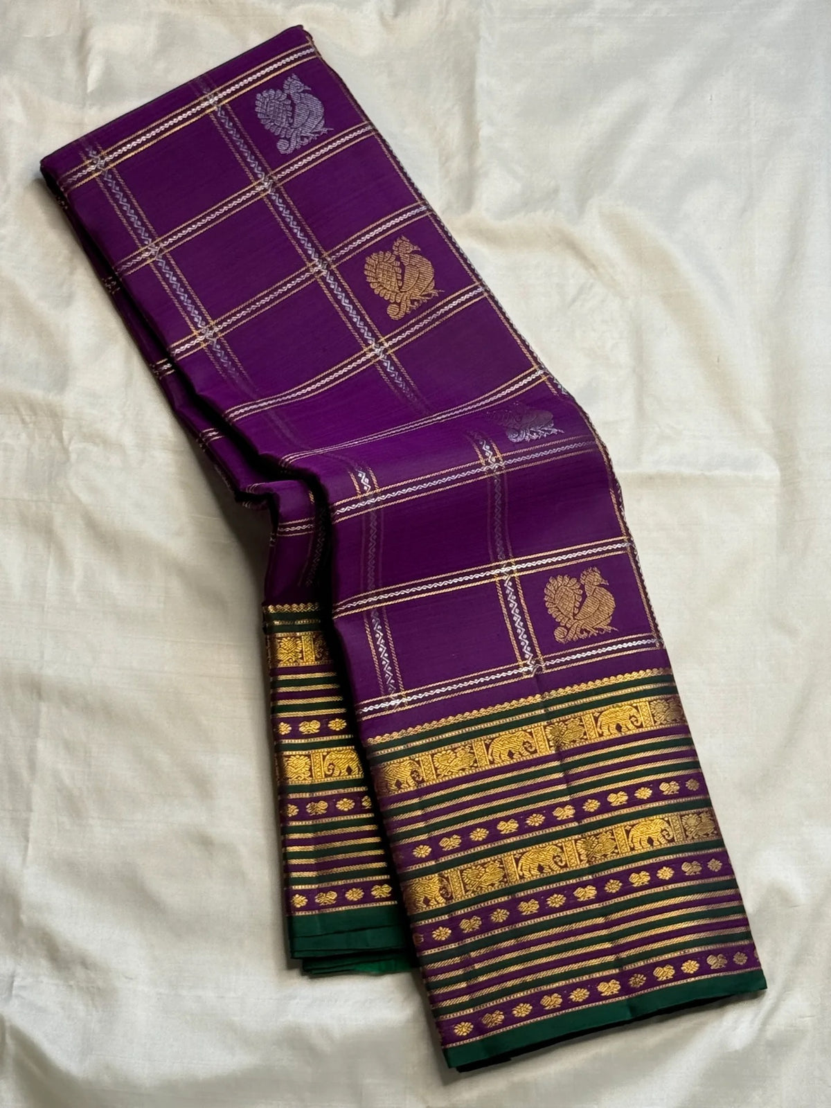 Alternating circular medallions and smaller traditional buttas across a purple zari lattice body.