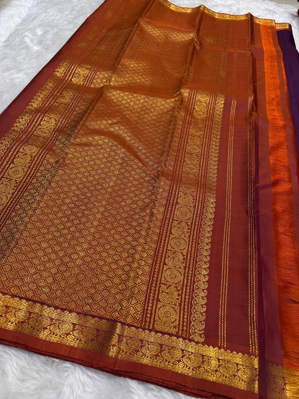 Plum Purple and Burnt Rust colour contrast on handwoven Kanchipuram silk saree.
