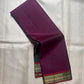 Green and purple pure Kanchipuram silk saree laid open showing narrow antique gold zari border and contrast color division