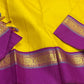 Close view of purple border with gold zari woven motifs on a yellow pure Kanchipuram silk saree