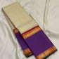 Pure Kanchipuram silk saree with ivory body featuring subtle zari stripes and contrast purple border