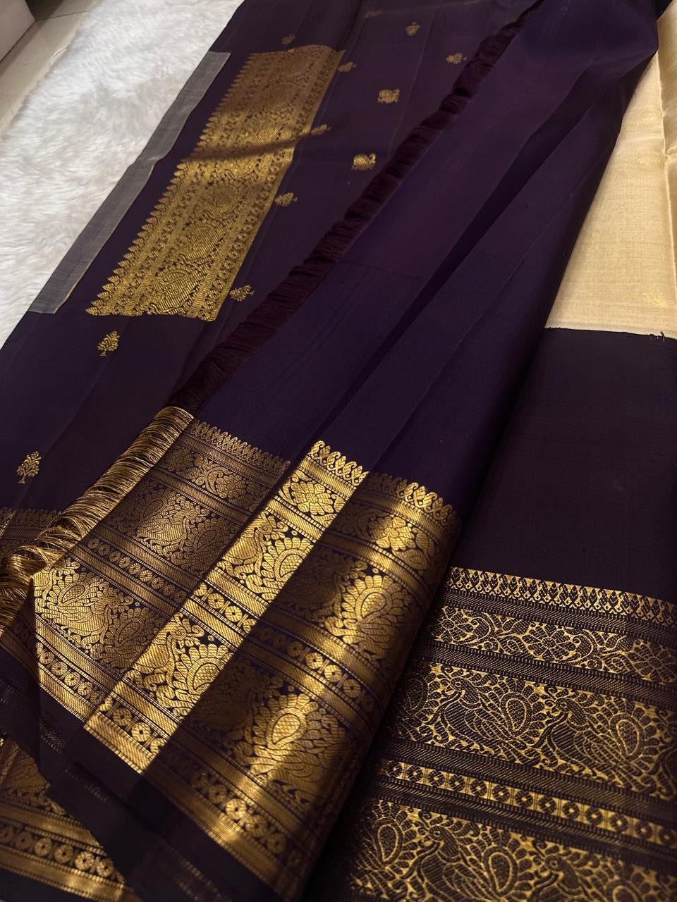 Traditional Kanchipuram silk saree in regal aubergine with peacock zari border detailing