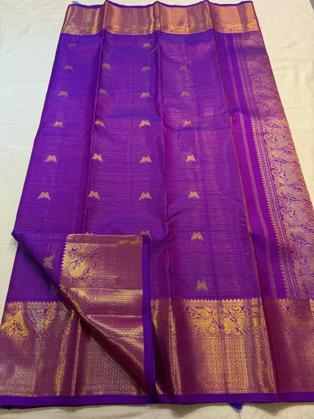 Close view of handwoven Twin Bird zari buttas across Kathiripoo Purple Vairaoosi silk.