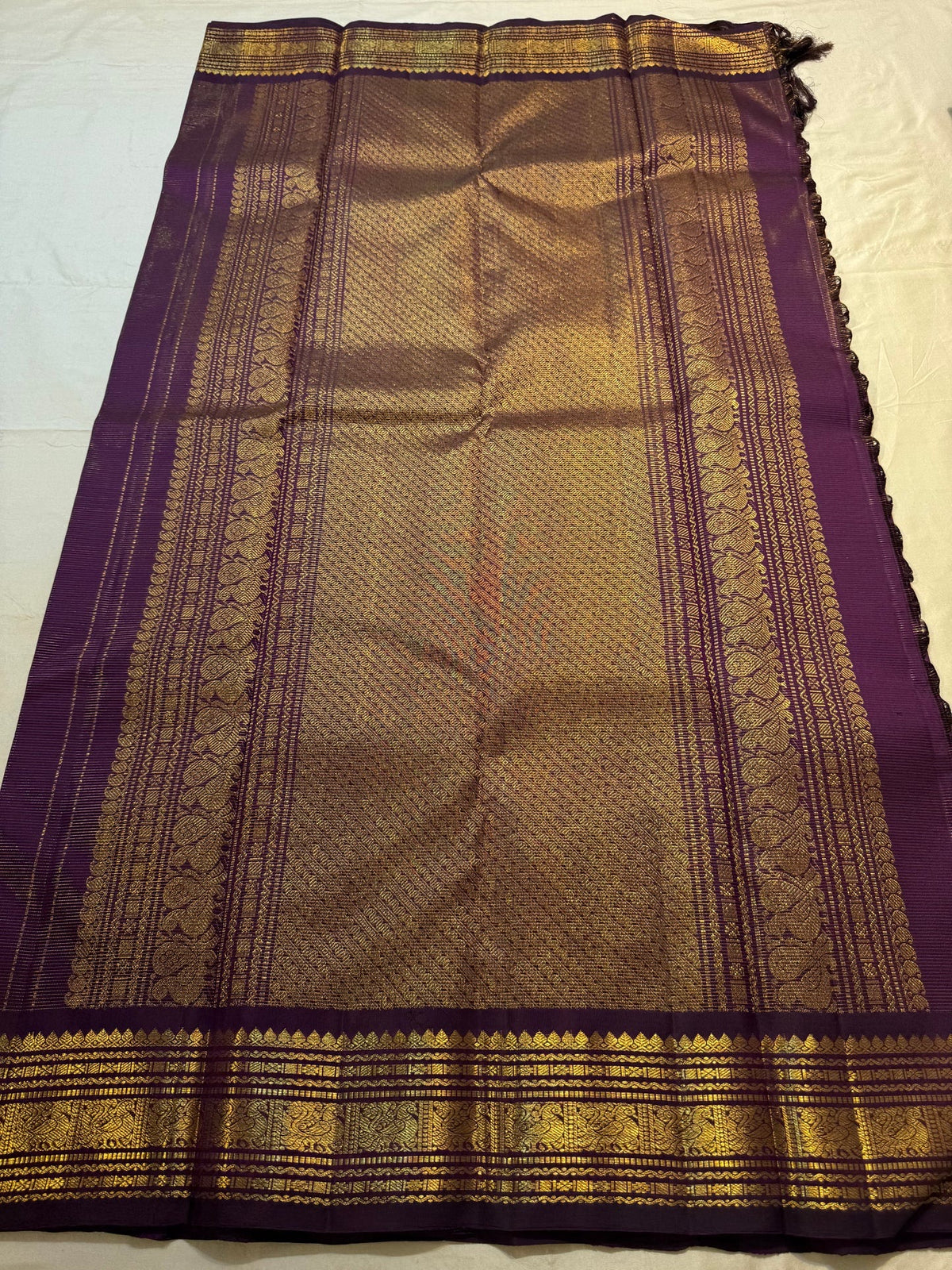 Detail of the Vairaoosi zari lines and gold buttas on the purple Kanjipuram saree