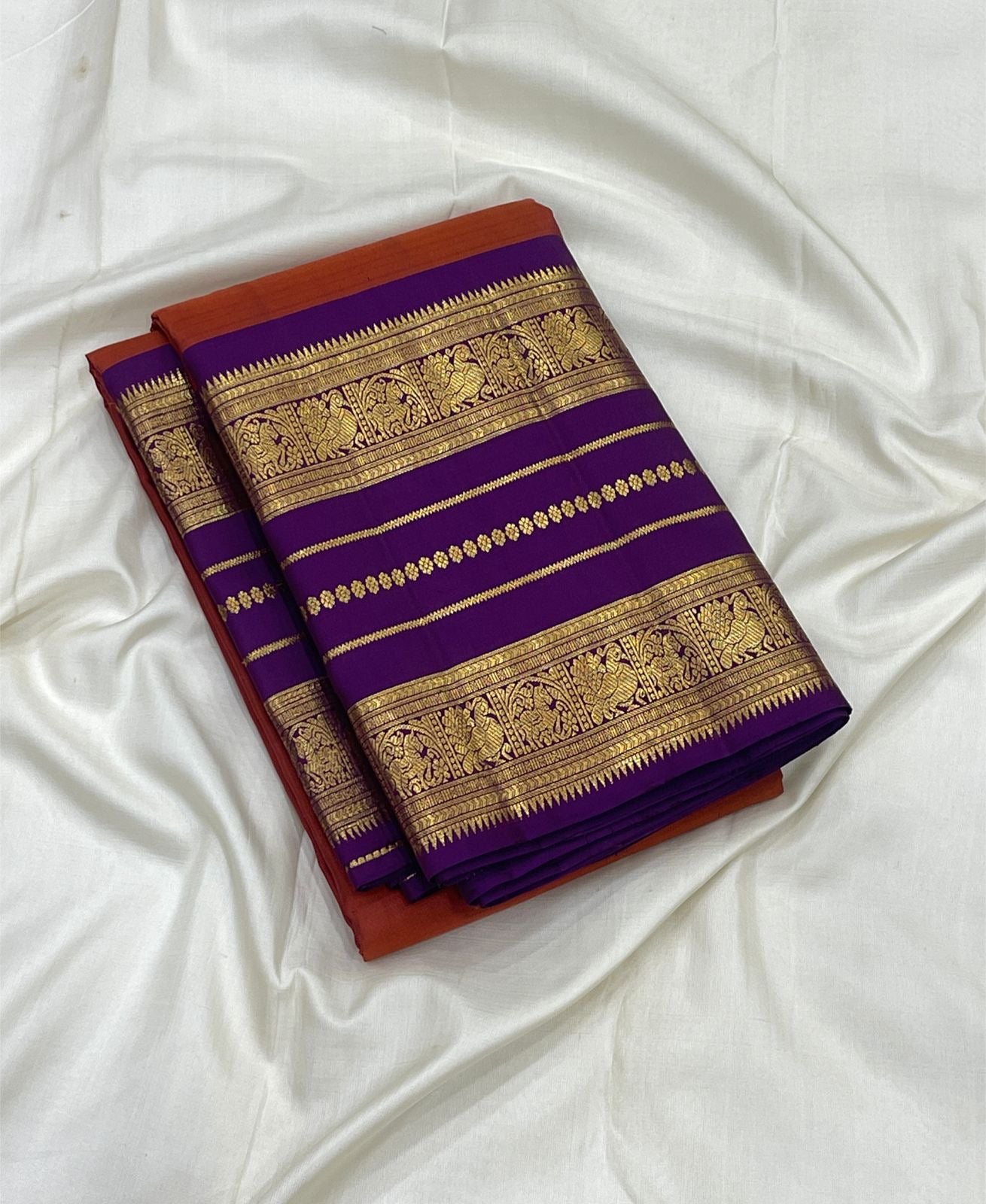 Close view of repeated gold zari registers on Kathiripoo Purple Varisaipet border.