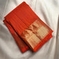Radiant Burnt Orange handwoven pure silk Kanjivaram Butta saree with antique-gold zari detailing.