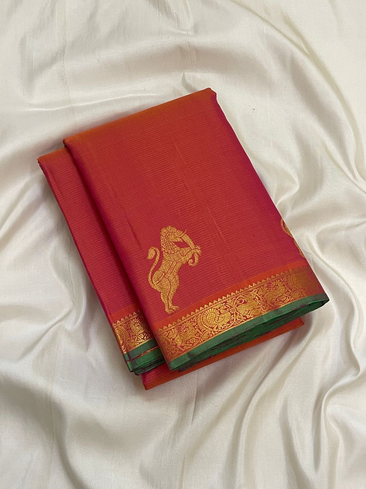 Radiant Coral Rose pure silk Kanchipuram Vairaoosi saree with handwoven Yazhi gold zari motifs.