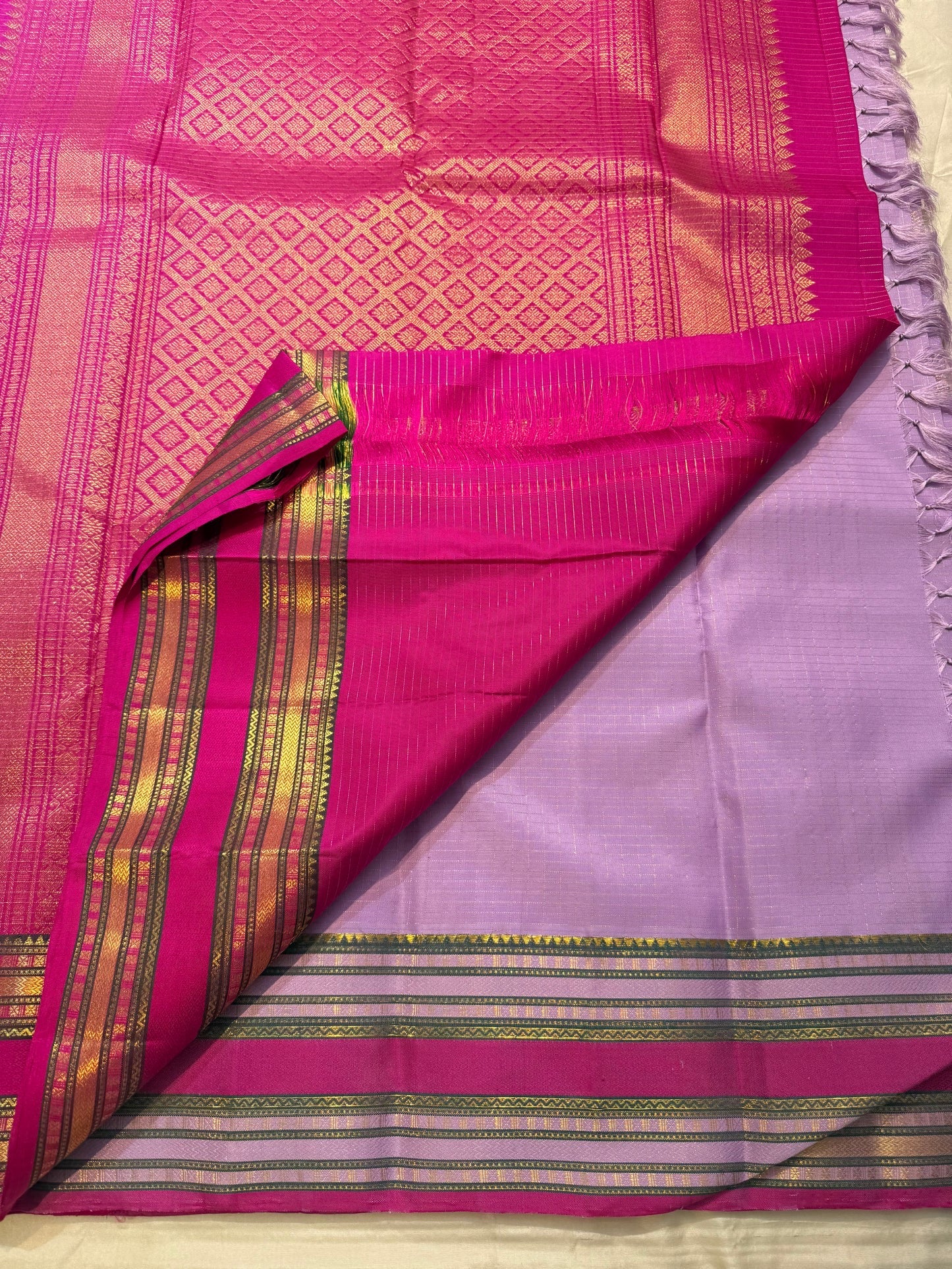 Silk thread mayil chakram butta close-up on radiant lavender Kanchipuram pure silk saree — Idam Living