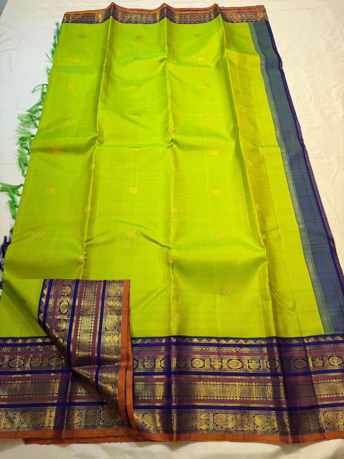 Radiant lime-green Pure Silk Kanchipuram Varisaipet saree with petite zari buttas and stacked contrast border.