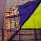 Full lime-green handwoven Kancheepuram silk saree with deep indigo-purple and gold zari border registers.