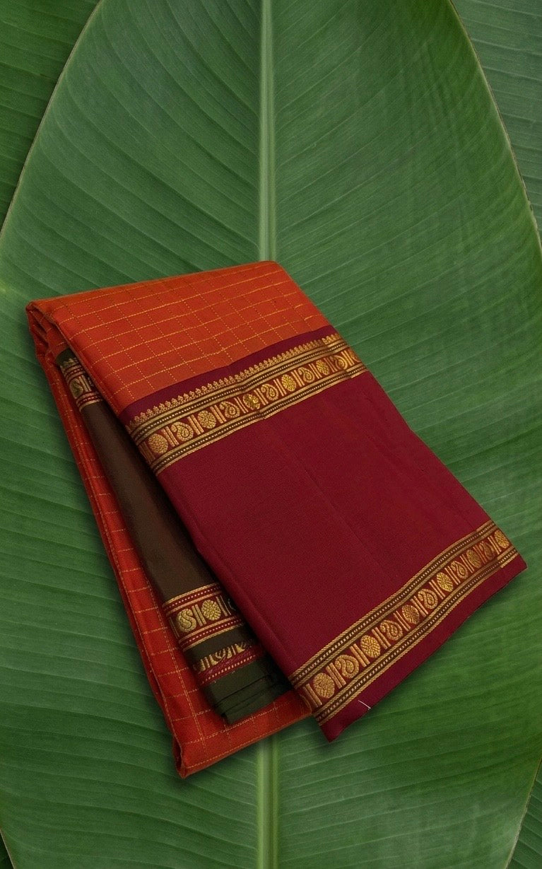 Radiant orange Kanchipuram silk saree with Ganga Jamuna border and traditional gold zari