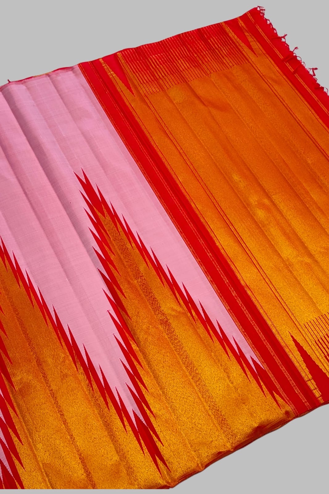 Ettukol gold zari and red accent flames on radiant pink Kancheepuram silk saree border — Idam Living