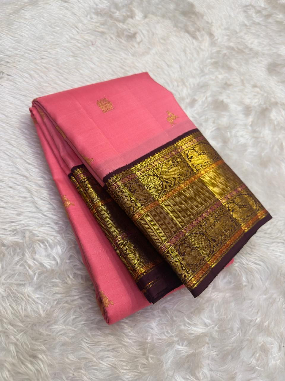 Deep plum Varisaipet border with Yazhi motifs in gold zari on radiant pink Kanjeevaram saree